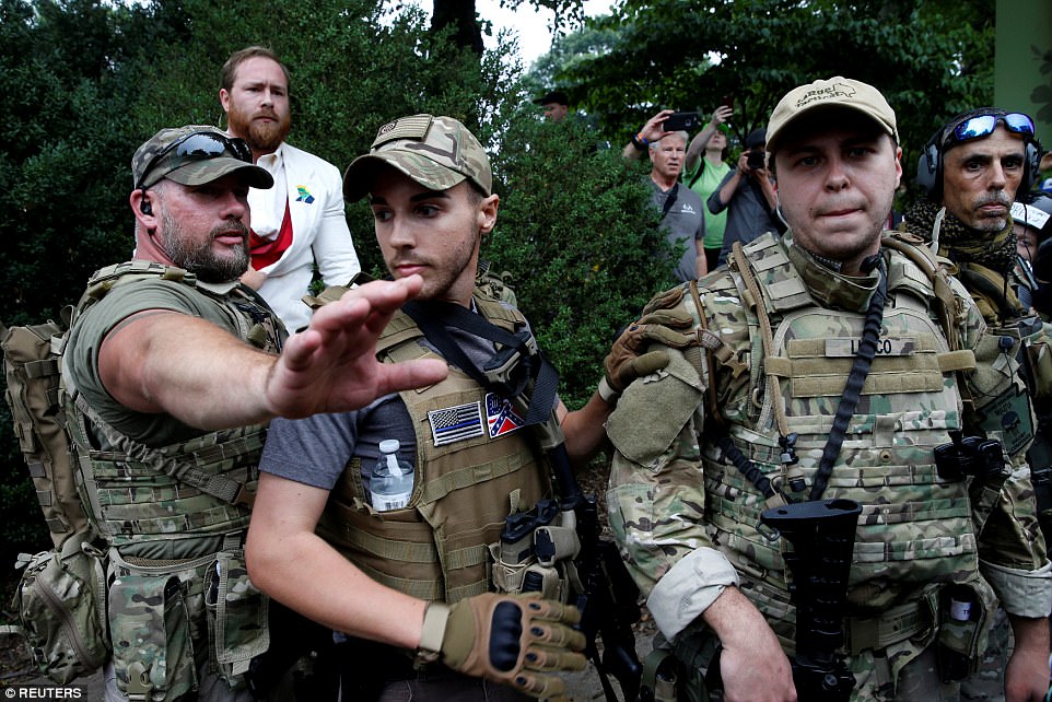 4331F60C00000578-4783914-A_white_supremacist_stands_behind_militia_members_after_he_scuff-a-4_1502575625754.jpg